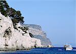 Boat next to cliffs on the Cote d'Azur, France