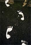 White foot prints on street.