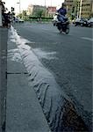 Water flowing along street gutter