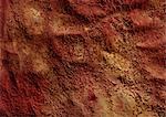 Warm-toned pigments on textured surface, close-up, full frame