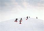 Sweden, sledders walking up hill