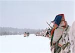 Finland, saamis with reindeer sleds in line, rear view