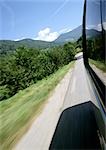 Car window and side of road, close-up, blurred motion