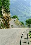 France, Savoie, Alpes, road curving around mountainside