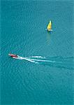 Motor boat and sail boat at sea, aerial view