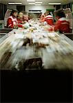 People working in assembly line, blurred