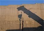Shadow of crane projected onto wall