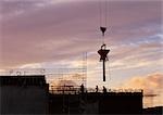 Construction site, silhouette, sky at sunset in background