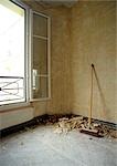 Broom leaning against wall in room