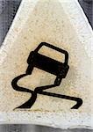 Slippery road sign, close-up
