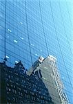 Buildings reflected in window panes of skyscraper