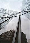 Building reflected in skyscraper's facade, low angle view