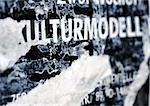 Cultural model text in German printed on torn poster, close-up