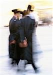 Israel, Jerusalem, Orthodox Jews walking in street, blurred