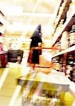 Woman standing in supermarket, blurred