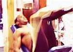Homme à l'aide de poids machine dans une salle de sport, flou de mouvement