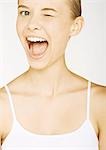 Young woman in tank top winking, portrait