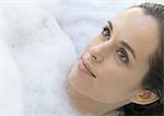 Woman in bubble bath, close-up
