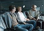 Travelers chatting in airport lounge