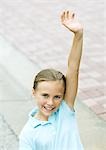 Girl raising hand, smiling