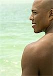 Man smiling, profile, sea in background