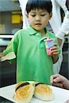 Boy looking at tray of food