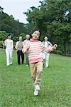 Girl dancing while parents and grandparents watch in background