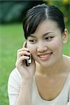 Woman using cell phone, close-up