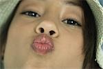 Teenage girl puckering lips at camera, close-up