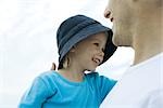 Man holding daughter, both smiling