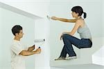 Man and woman painting home interior