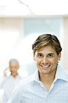 Businessman, smiling at camera, portrait