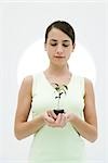 Woman holding potted seedling, looking down