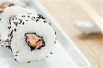 Maki sushi rolled in black sesame seeds, close-up