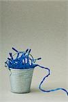 Miniature bucket filled with blue Christmas tree lights