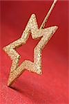 Golden star shaped Christmas tree ornament, upside down