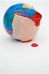 Adhesive bandage dripping blood wrapped around globe