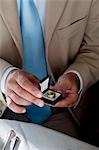 Closeup of hands of young man holding a ring in an open jewelry box