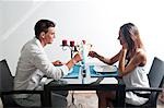 Couple sitting at table drinking white wine