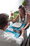 Couple sitting at table drinking white wine