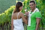 Couple in vineyard with white wine