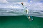 Message in a bottle floating in ocean