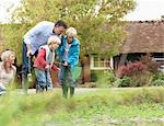 Family relaxing by pond