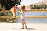 Girl on jetty with kite