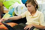 Preteen boy using laptop computer