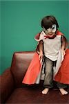 Boy in costume standing on sofa