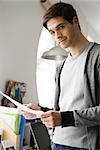 Man with look of satisfaction holding document