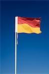 The iconic red and yellow flag of Australian lifesaving. Pairs of flags are used to mark areas of the beach patrolled by lifesavers and safe for swimming