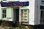 A crafts shop sells curios to tourists at the old fishing village of Mousehole,Cornwall,England