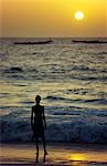 A boy watches the sun set over the Atlantic at Plage des Pecheurs (Fishermens Beach) on the south coast of Mauritania. The waters off the west African nation are regarded as one of the richest fishing areas in the world.